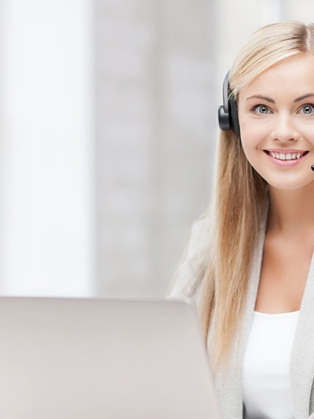 woman wearing a headset at a computer